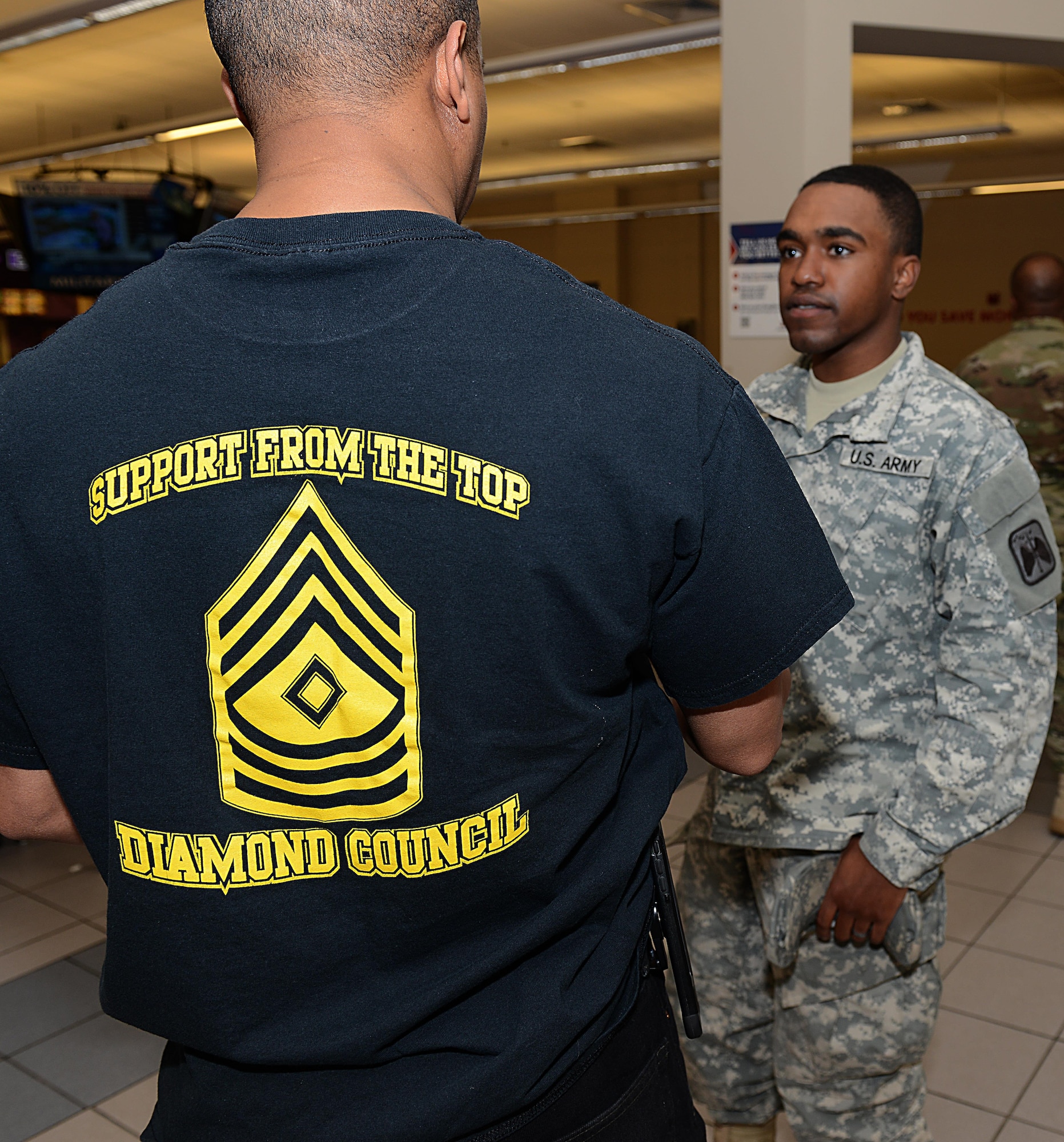 U.S. Army Master Sgt. Nolan Hills, Headquarters and Headquarters Company, 128th Aviation Brigade division chief and Fort Eustis Diamond Council secretary, speaks with a Soldier at Joint Base Langley-Eustis, Va., March 9, 2017. The Diamond Council presented approximately $400 in gift cards to junior enlisted service members to thank them for their service and hard work. (U.S. Air Force photo/Staff Sgt. Teresa J. Cleveland)