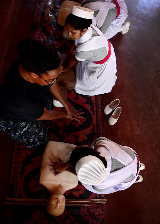 Navy Corpsman Unique Mooney teaches two local nursing students basic life savings skills during Pacific Partnership 2017 in Hambantota, Sri Lanka, March 10, 2017. Navy photo by Petty Officer 1st Class Micah Blechner