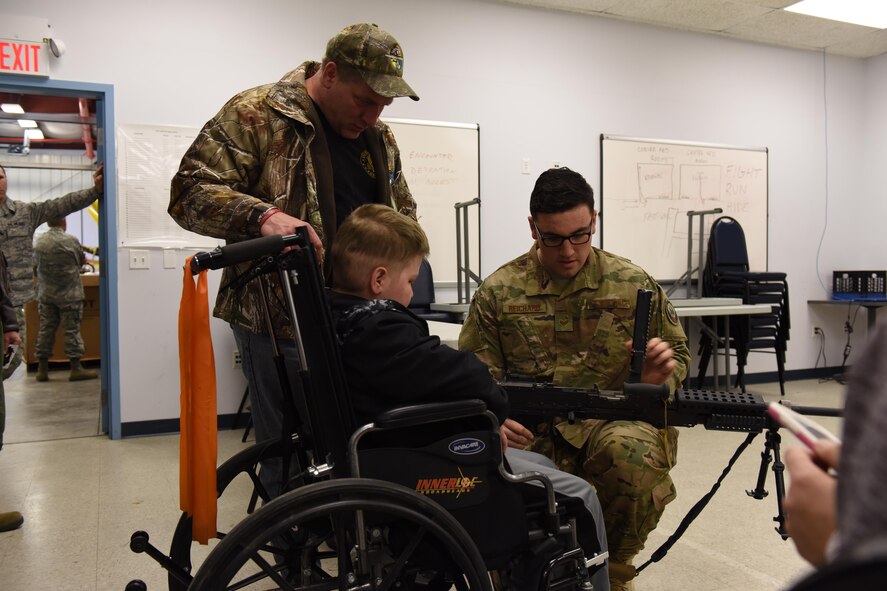 Staff Sgt. Alex Reichard, security forces specialist, 193rd Special Operations Security Forces Squadron shows Ayden Zeigler-Kohler and Ayden’s father Bill Kohler a M240B machine gun during Ayden’s visit to the 193rd Special Operations Wing, Middletown, Pennsylvania, March 10, 2017. Airmen and Dowty Propellers field service representative, spent the afternoon making memories for Ayden and his family. August 2016, Ayden 10, was diagnosed with diffuse intrinsic pontine glioma, a rare childhood cancer. (U.S. Air National Guard Photo by Master Sgt. Culeen Shaffer/Released)
