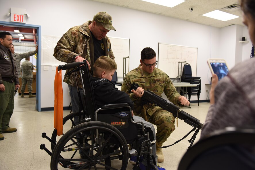 Staff Sgt. Alex Reichard, security forces specialist, 193rd Special Operations Security Forces Squadron shows Ayden Zeigler-Kohler and Ayden’s father Bill Kohler a M240B machine gun during Ayden’s visit to the 193rd Special Operations Wing, Middletown, Pennsylvania, March 10, 2017. Airmen and Dowty Propellers field service representative, spent the afternoon making memories for Ayden and his family. August 2016, Ayden 10, was diagnosed with diffuse intrinsic pontine glioma, a rare childhood cancer. (U.S. Air National Guard Photo by Master Sgt. Culeen Shaffer/Released)