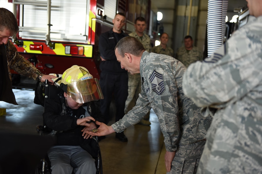 Chief Master Sgt. Robert Shartle, 193rd Special Operations Civil Engineering Squadron chief of operations, presents Ayden Zeigler-Kohler with a squadron coin during Ayden’s visit to the 193rd Special Operations Wing, Middletown, Pennsylvania, March 10, 2017. Airmen and Dowty Propellers field service representative, spent the afternoon making memories for Ayden and his family. August 2016, Ayden 10, was diagnosed with diffuse intrinsic pontine glioma, a rare childhood cancer. (U.S. Air National Guard Photo by Master Sgt. Culeen Shaffer/Released)