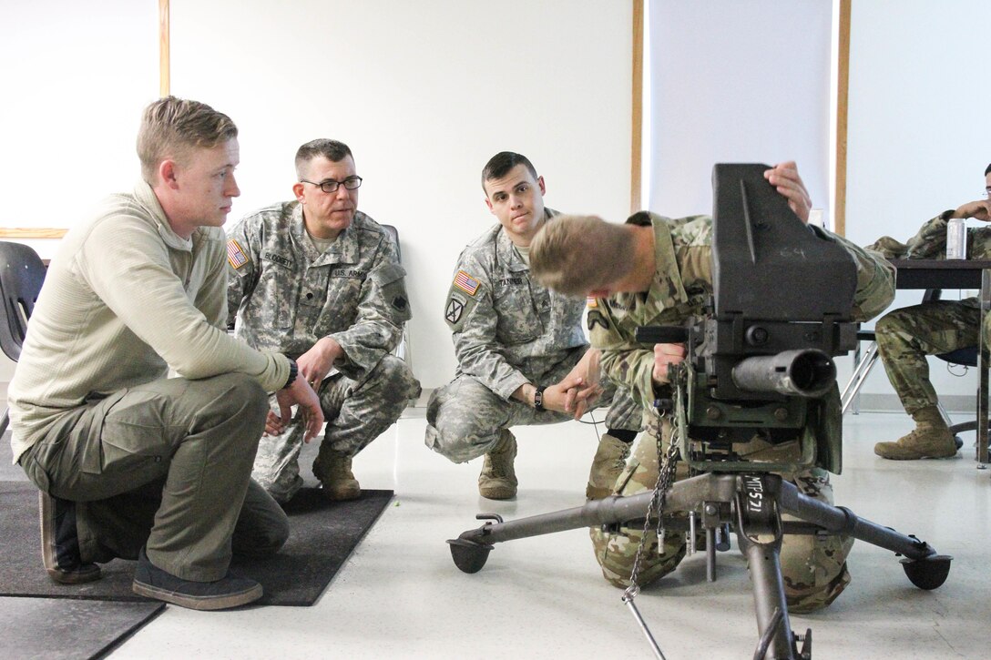 U.S. Army Reserve Sgt. Timothy McCoy, preliminary marksmanship instructor, demonstrates how to perform a function check on an MK-19 automatic grenade launcher during preliminary marksmanship instruction during Operation Cold Steel at Fort McCoy, Wis., March 12, 2017. Operation Cold Steel is the U.S. Army Reserve's crew-served weapons qualification and validation exercise to ensure that America's Army Reserve units and soldiers are trained and ready to deploy on short-notice and bring combat-ready and lethal firepower in support of the Army and our joint partners anywhere in the world. (U.S. Army Reserve photo by Staff Sgt. Debralee Best, 84th Training Command)