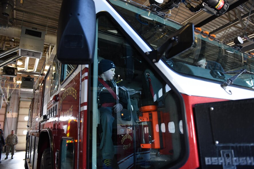 Ayden Zeigler-Kohler, Ayden’s mom Jen Zeigler and Master Sgt. Christopher Traugh, 193rd Special Operations Maintenance Squadron aircraft engine mechanic, ride in a fire truck during their visit at the 193rd Special Operations Wing, Middletown, Pennsylvania, March 10, 2017. Ayden’s tour escort Traugh, other 193rd SOW Airmen and Dowty Propellers field service representative, spent the afternoon making memories for Ayden and his family. August 2016, Ayden 10, was diagnosed with diffuse intrinsic pontine glioma, a rare childhood cancer. (U.S. Air National Guard Photo by Master Sgt. Culeen Shaffer/Released)