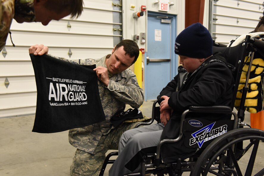 Master Sgt. Christopher Traugh, 193rd Special Operations Maintenance Squadron aircraft engine mechanic, presents some gifts to Ayden Zeigler-Kohler on behalf of 193rd Special Operations Wing during Ayden’s visit to the 193rd SOW, Middletown, Pennsylvania, March 10, 2017. Traugh who was Ayden’s tour escort, Airmen and Dowty Propellers field service representative, spent the afternoon making memories for Ayden and his family. August 2016, Ayden 10, was diagnosed with diffuse intrinsic pontine glioma, a rare childhood cancer. (U.S. Air National Guard Photo by Master Sgt. Culeen Shaffer/Released)
