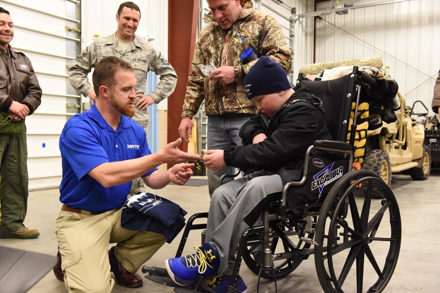 Jeffrey Beerer, Dowty Propellers field service representative, presents some gifts to Ayden Zeigler-Kohler on behalf of Dowty, a contracting company at the 193rd Special Operations Wing during Ayden’s visit to the 193rd SOW, Middletown, Pennsylvania, March 10, 2017. Airmen and Beerer, spent the afternoon making memories for Ayden and his family. August 2016, Ayden 10, was diagnosed with diffuse intrinsic pontine glioma, a rare childhood cancer. (U.S. Air National Guard Photo by Master Sgt. Culeen Shaffer/Released)