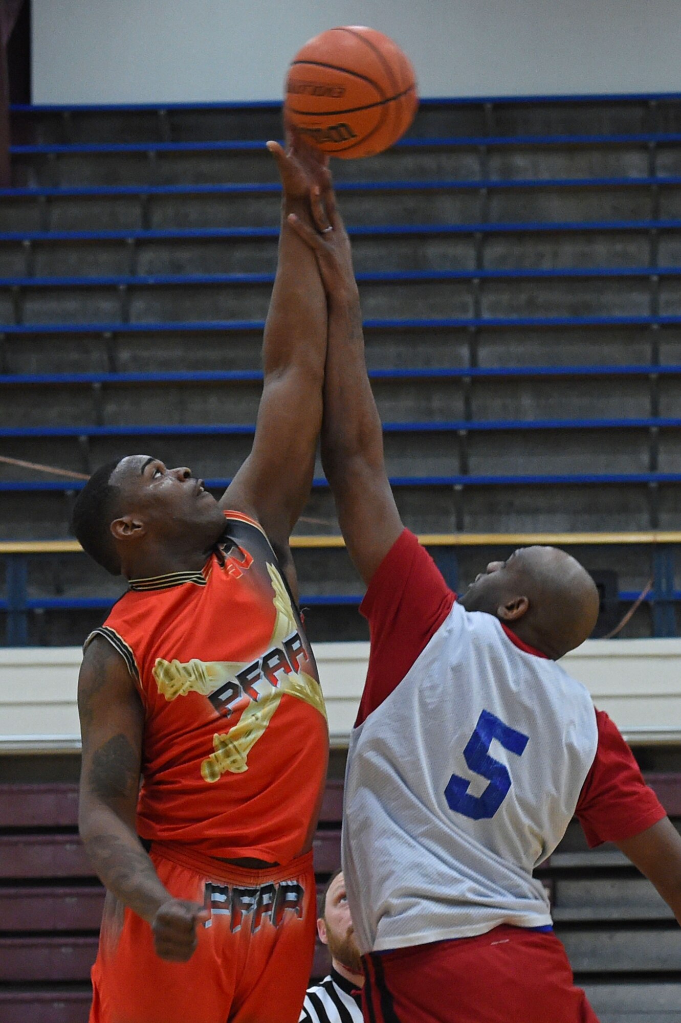 Arlandus Williams, left, and Joseph Huewitt, right, jump for the ball during tip-off, starting the intramural basketball championship at the Joint Base Elmendorf-Richardson Buckner Physical Fitness Center, Alaska, March 11, 2017. Soldiers from Alpha Company, 6th Brigade Engineer Battalion, 4th Infantry Brigade Combat Team (Airborne), 25th Infantry Division, took first place against Soldiers from the 2nd Battalion, 377th Parachute Field Artillery Regiment, 4/25th IBCT (A). 