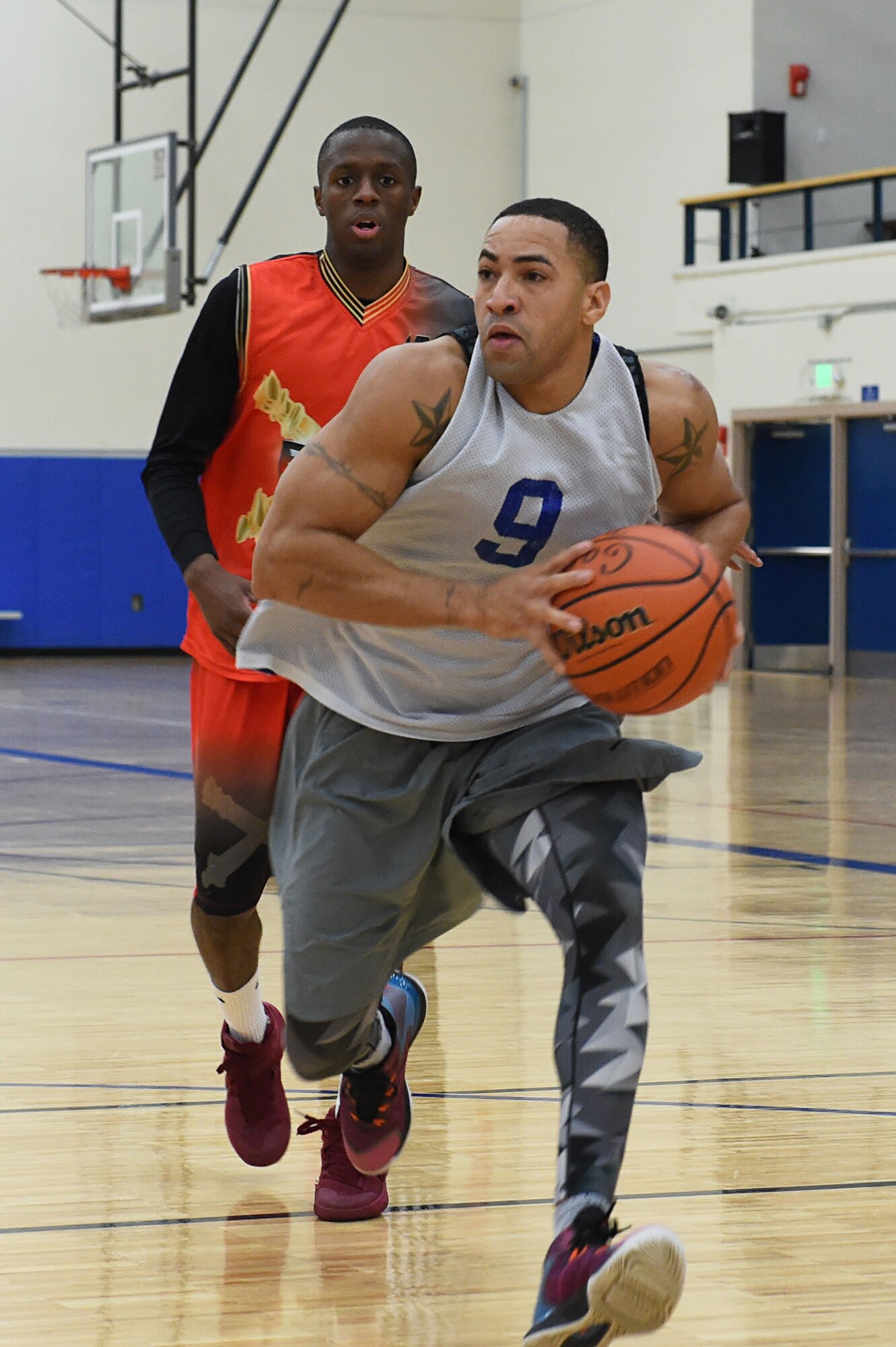 Duriel Mitchem, front, dribbles past Cedric Barfield during the intramural basketball championship at the Joint Base Elmendorf-Richardson Buckner Physical Fitness Center, Alaska, March 11, 2017. Soldiers from Alpha Company, 6th Brigade Engineer Battalion, 4th Infantry Brigade Combat Team (Airborne), 25th Infantry Division, took first place against Soldiers from the 2nd Battalion, 377th Parachute Field Artillery Regiment, 4/25th IBCT (A). 