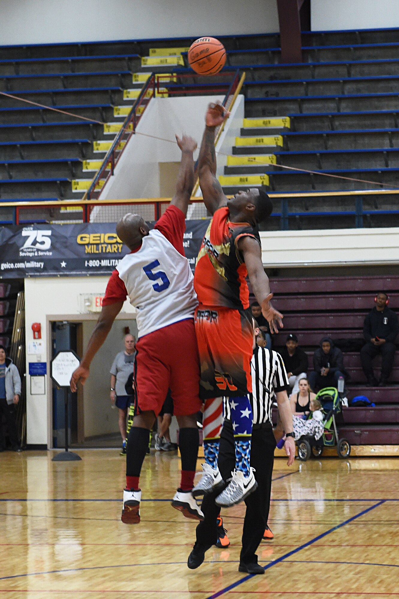 Joseph Huewitt, left, and Arlandus Williams, right, jump for the ball during tip-off, starting the second half of the intramural basketball championship at the Joint Base Elmendorf-Richardson Buckner Physical Fitness Center, Alaska, March 11, 2017. Soldiers from Alpha Company, 6th Brigade Engineer Battalion, 4th Infantry Brigade Combat Team (Airborne), 25th Infantry Division, took first place against Soldiers from the 2nd Battalion, 377th Parachute Field Artillery Regiment, 4/25th IBCT (A). 