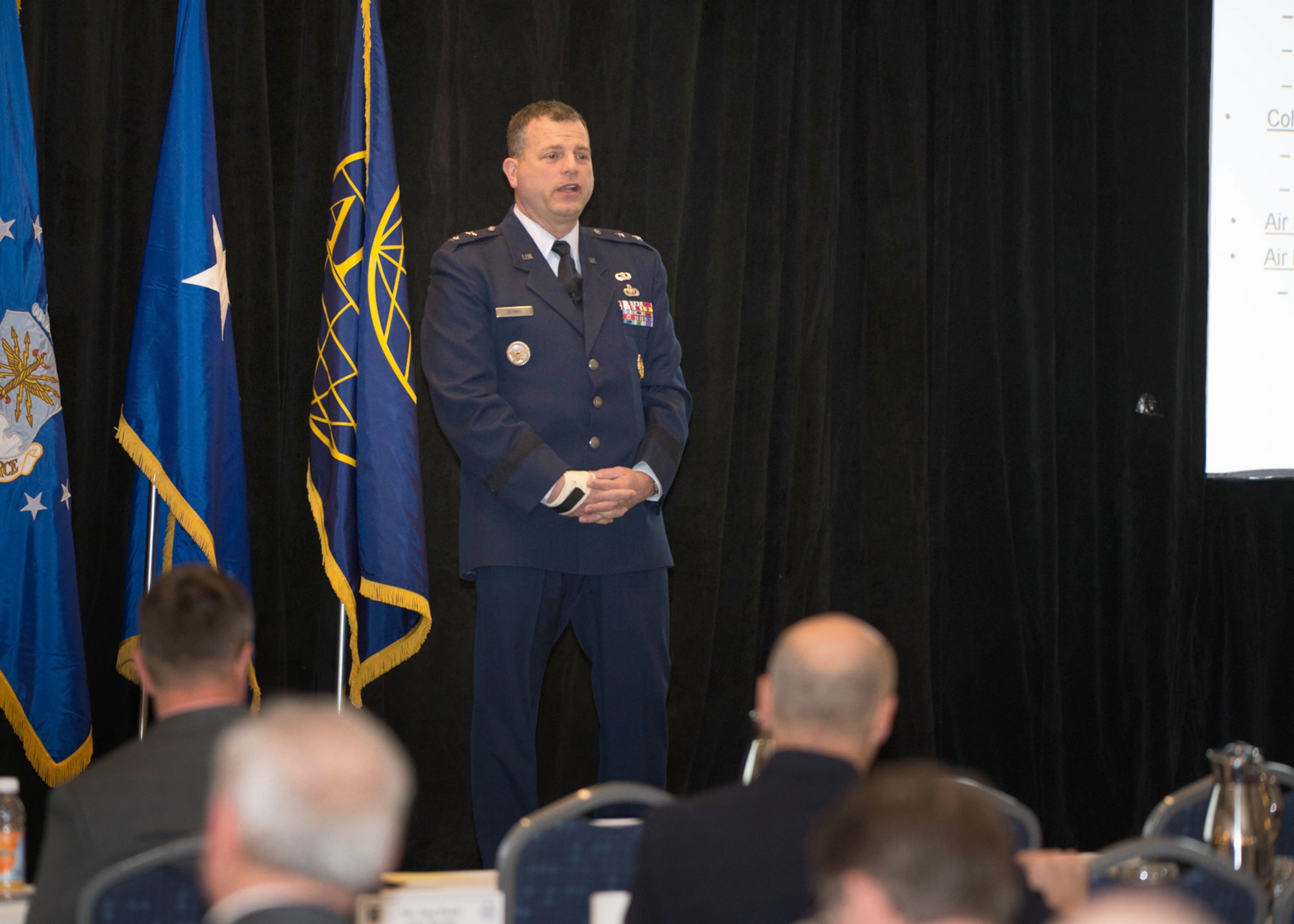 Maj. Gen. Dwyer Dennis, Command, Control, Communications, Intelligence and Networks program executive officer, speaks to the audience at the annual New Horizons symposium in Newton, Mass., on March 14. Dennis, along with the other PEOs from Hanscom Air Force Base, Mass., presented business opportunities and spoke about ongoing and upcoming work during the two-day event, which was conducted despite blizzard conditions throughout the Northeast. (U.S. Air Force photo by Jerry Saslav) 