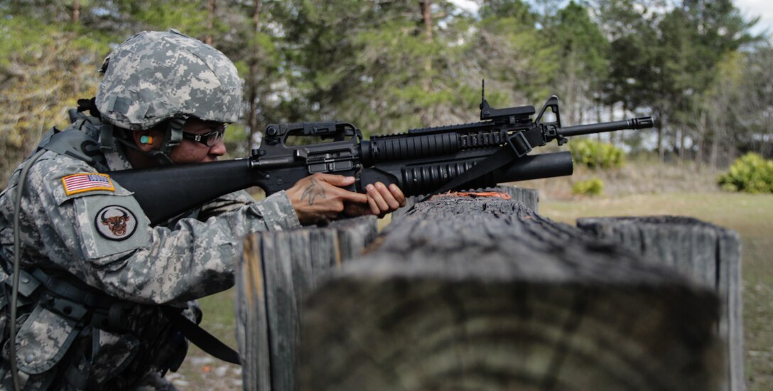 Army Sgt. Megan Garrett, a Columbia, S.C., native serving as a motor transport operator in the 207th Transportation Company, rests her M203 Grenade Launcher on a wooden mall as she prepares to fire a paint round at a target during the 143d Sustainment Command (Expeditionary) Best Warrior Competition weapons qualification event March 9, 2017, in Camp Blanding, Fla. Weapons qualification was one of the myriad of tests, exercises and simulations that evaluated each competitor’s capability, a competency and capabilities in the field.  (U.S. Army photo by Sgt. John L. Carkeet IV, 143d ESC)