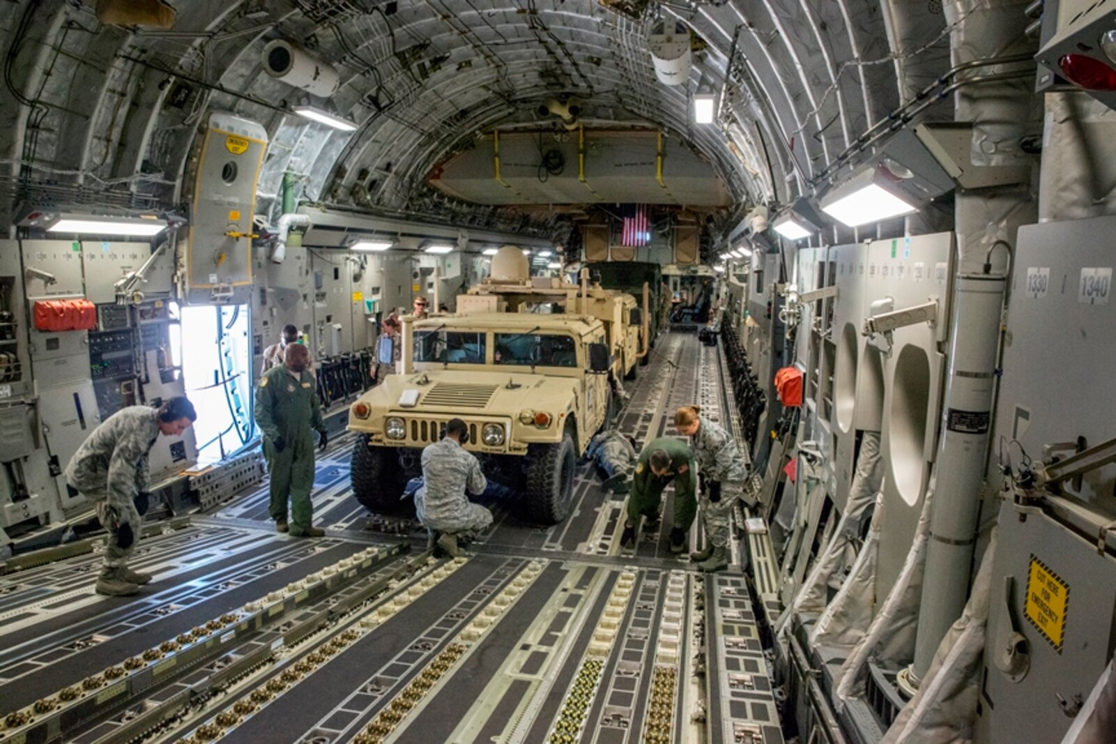 Airmen with 50th Aerial Port Squadron, 452nd Air Mobility Wing, strap down three Marine Corps High Mobility Multipurpose Wheeled Vehicles (HMMWV) that are parked in the loading bay of an Air Force C-17 Globemaster III aircraft during Strategic Mobility Exercise on March Air Force Reserve Base, Calif., March 12, 2017. STRATMOBEX is a training exercise conducted by the 1st Marine Logistics Group in order to maintain readiness and sharpen skills needed to rapidly deploy personnel and equipment on a large scale.