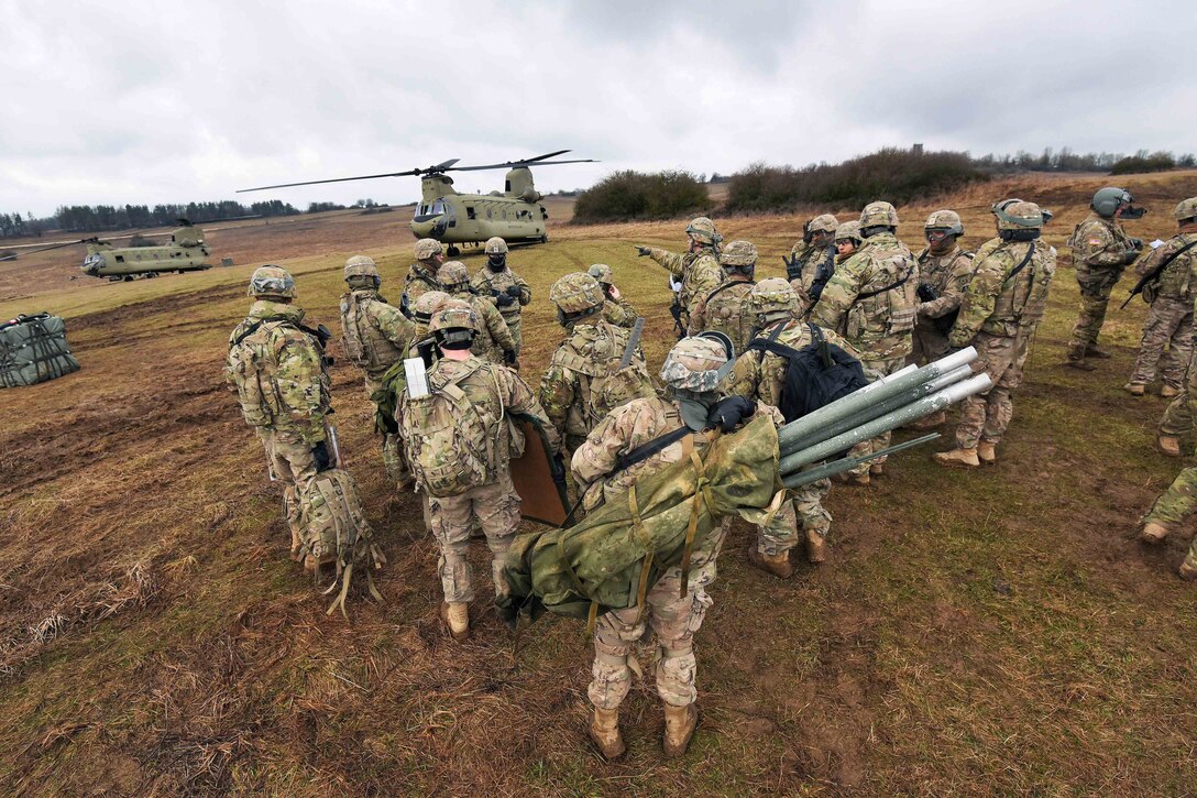 Soldiers receive a mission and safety briefing during slingload operations at the 7th Army Training Command's Grafenwoehr Training Area, Germany, March 9, 2017. The soldiers, assigned to Field Artillery Squadron, 2nd Cavalry Regiment, received support from the 12th Combat Aviation Brigade as they participated in exercise Dynamic Front II with nearly 1,400 participants from nine NATO nations. It focused on developing solutions by testing interoperability at the tactical level. Army photo by Gertrud Zach