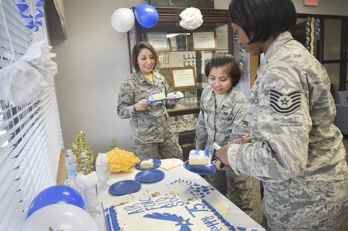 Tech. Sgt. Eva Simmons, right, 628th Force Support Squadron readiness NCO in charge, serves cake to Airman 1st Class Vanessa Ortiz, left, and Airman 1st Class Lorelie Budioganon, center, both assigned to the 628th Force Support Squadron, during an event celebrating the 75th Anniversary of the Air Force Aid Society at the Airman and Family Readiness Center here, March 10, 2017. The AFAS is a private non-profit organization working to provide relief to Air force members and their families in financial distress and to assist in their pursuit of higher education goals. There are four charities that service members can donate to as part of the Air Force Assistance Fund campaign (AFAF). Those interested in the AFAF campaign have until April 14 to make pledges.