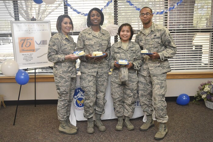 Airmen pose for a photo during an event celebrating the Air Force Aid Society’s 75th Anniversary at the Airman and Family Readiness Center here, March 10, 2017. The AFAS is a private non-profit organization working to provide relief to Air force members and their families in financial distress and to assist in their pursuit of higher education goals. There are four charities that service members can donate to as part of the Air Force Assistance Fund campaign (AFAF). Those interested in the AFAF campaign have until April 14 to make pledges.