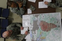Forest Park, Ill. - Spc. Adam Parent, a journalist from the 220th Public Affairs Detachment in Southfield, Mich., shows off his map reading skills for Sergeant 1st Class Peter Vines, the acting first sergeant of the 318th Press Camp Headquarters during the Best Warrior Competition.