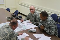 Forest Park, Ill. - Spc. Adam Parent, a journalist from the 220th Public Affairs Detachment, proves his map reading and basic warrior skills to Sergeant 1st Class Peter Vines and Sgt. Thomas Tallman of the 318th Press Camp Headquarters at the unit during the Best Warrior Competition Saturday afternoon.