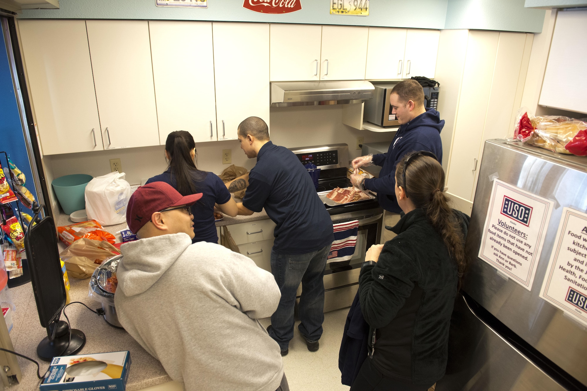 Members of the Air Force Sergeant’s Association prepare for their March 10 mentorship event at the United Services Organization by cooking bacon-wrapped hotdogs. The event was designed to create an environment where Airmen could speak honestly and have tough questions answered. 