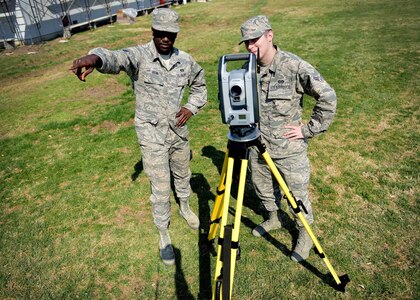 From left, U.S. Air Force Senior Airman Randall Brown and Airman 1st Class Ryan Mundt, 633rd Civil Engineer Squadron engineering technicians, prepare for an optical site survey at Joint Base Langley-Eustis, Va., March 9, 2017. Brown and Mundt are members of the mapping section, which keeps track of all on-base facilities and floor plans, as well as records of all renovations and floor plans of demolished buildings. (U.S. Air Force photo/Senior Airman Areca T. Bell)