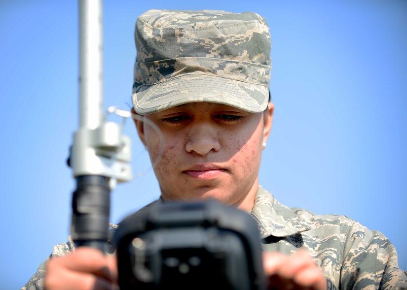 U.S. Air Force Airman Gabrielle Victor, 633rd Civil Engineer Squadron engineering technician, performs an optical site survey, at Joint Base Langley-Eustis, Va., March 9, 2017. Victor is a member of the mapping section, which produces 35 individual maps on a day-to-day basis that range from utility to airfield and environmental maps. (U.S. Air Force photo/Senior Airman Areca T. Bell)

