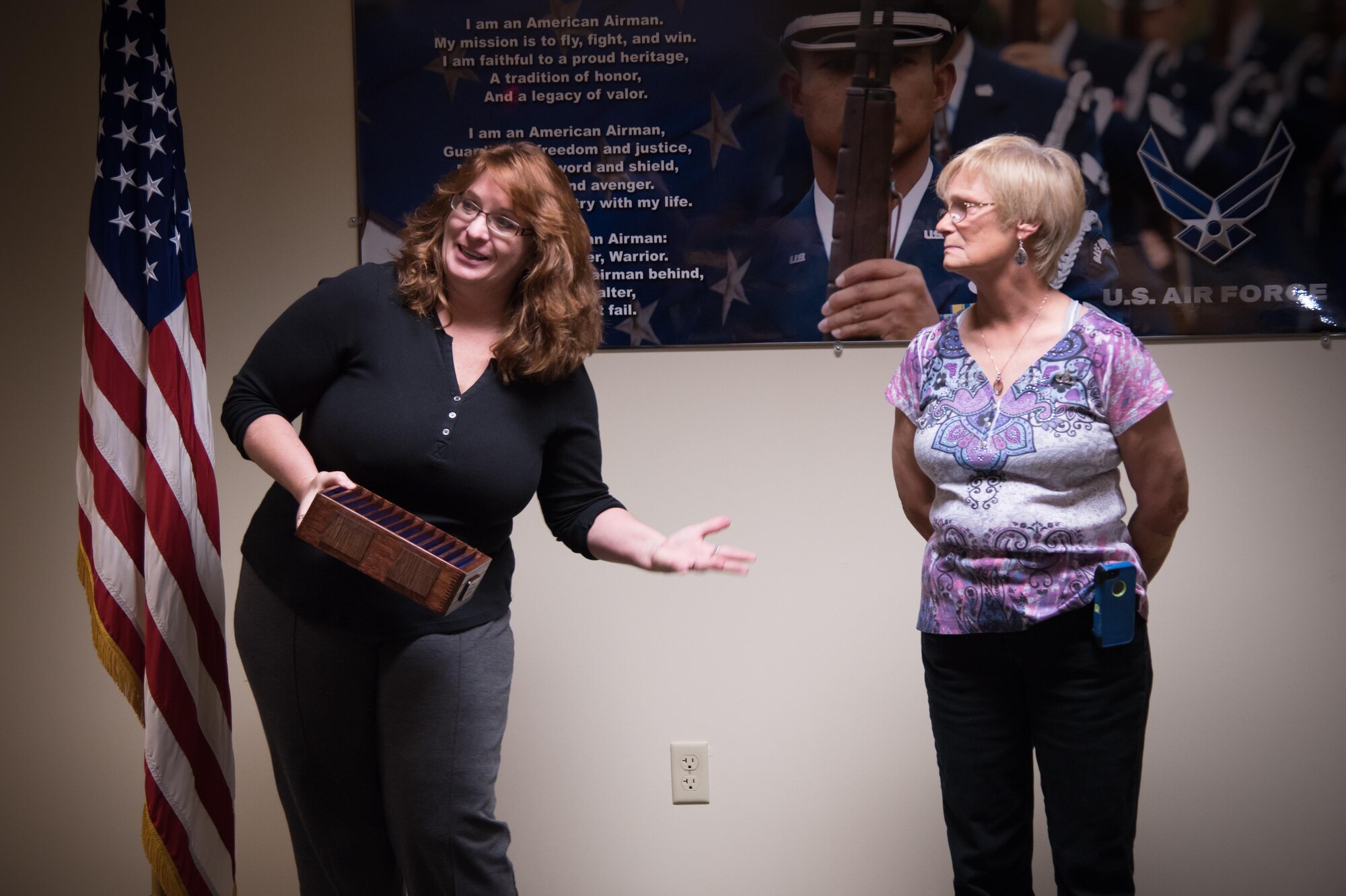 Renee Smith, 81st Operations Support Flight aviation resource manager presents a coin box to Libby Harper, 81st OSF host aviation resource management chief, during her retirement during a hertiage ceremony March 3 at Keesler Air Force Base, Mississippi. (U.S. Air Force photo/Staff Sgt. Heather Heiney) 
