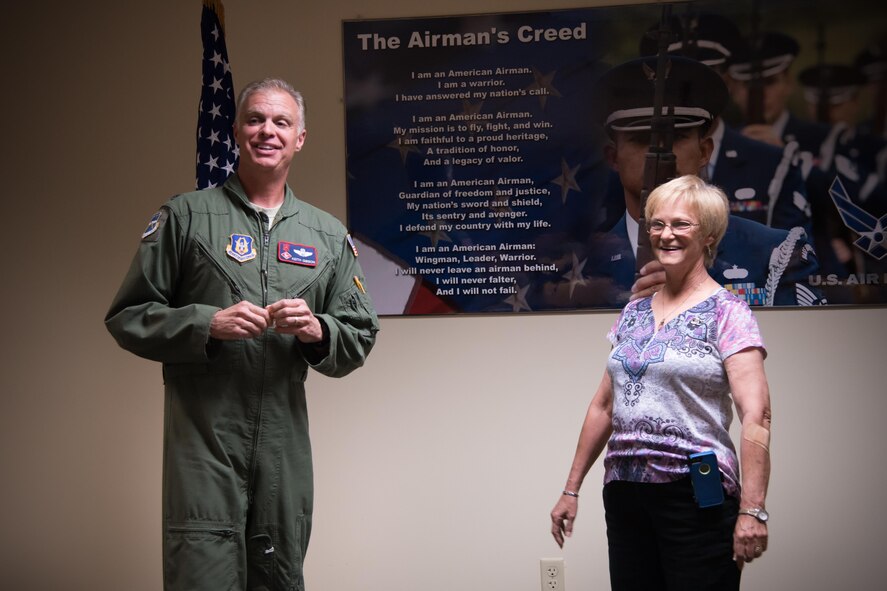 Lt. Col. Keith Gibson, 403rd Operations Group deputy commander speaks to Libby Harper, 81st 81st Operations Support Flight host aviation resource management chief, during her retirement and hertiage ceremony March 3 at Keesler Air Force Base, Mississippi. (U.S. Air Force photo/Staff Sgt. Heather Heiney)