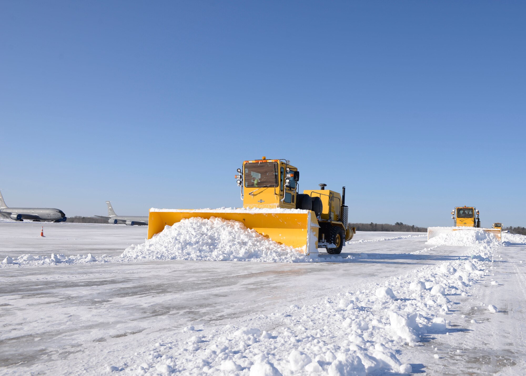 Airmen from Pease Snow Removal Team plow the flight line here, March 15. The team is composed of 20 Airmen and civilians working 12 hour shifts around the clock to clear more than 90 acres of the flight line as well as the roads and sidewalks around the base.