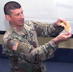 Lt. Col. Matthew Levine, Food Protection Branch chief in the Department of Veterinary Science, demonstrates to a group of Chilean veterinarians how to conduct a rapid field test to identify harmful bacteria in water during the subject matter expert exchange in Santiago, Chile. The exchange was March 6-9. 