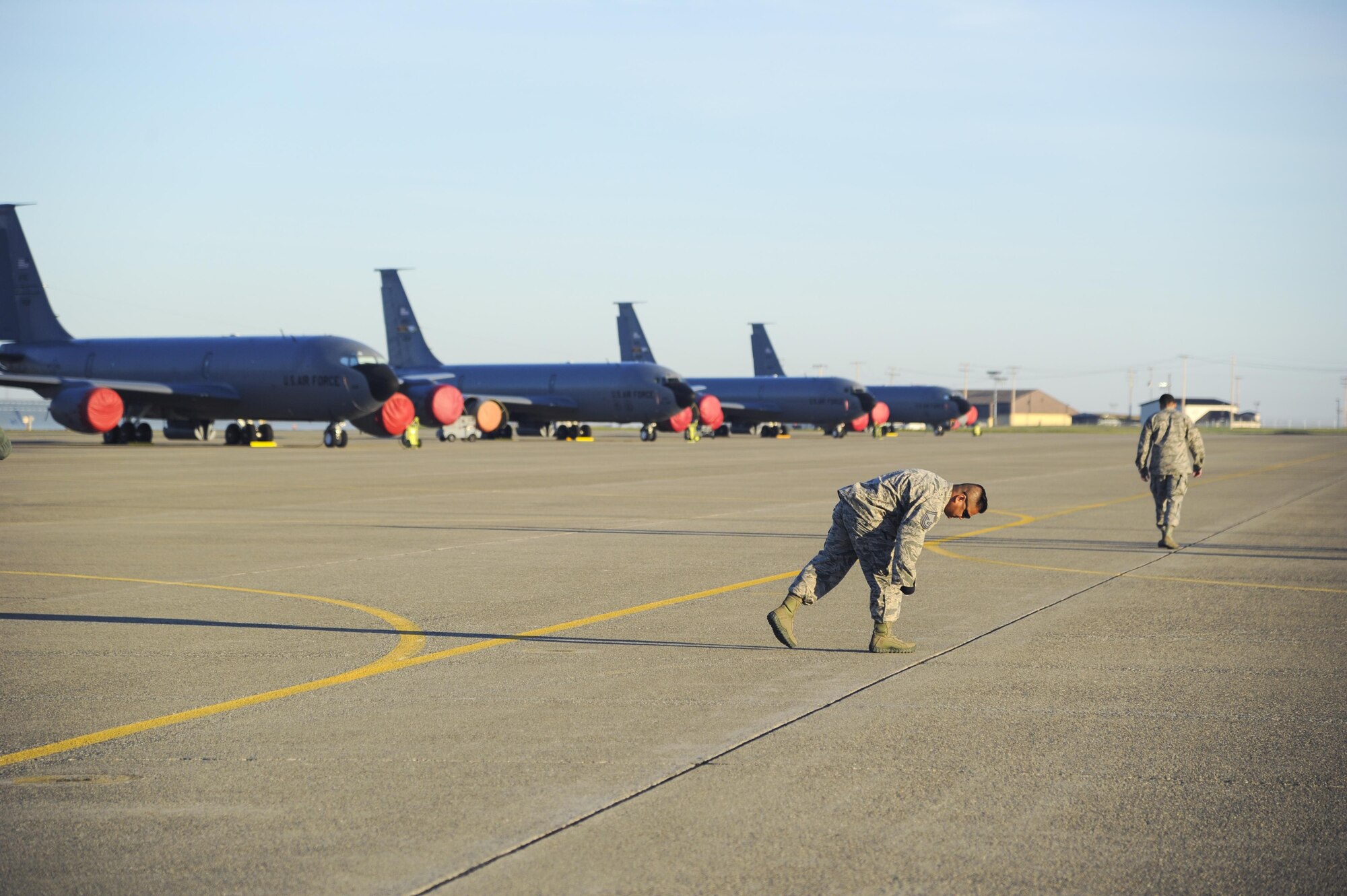 A member of the 940th Air Refueling Wing picks up a piece of debris on the flightline during a foreign object debris walk March 12, 2017, at Beale Air Force Base, California. The 940th Air Refueling Wing holds a FOD walk every Sunday of the unit training assembly weekend. (U.S. Air Force photo by Senior Airman Tara R. Abrahams)