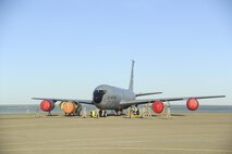 Members of the 940th Air Refueling Wing look for a foreign object debris near a KC-135 Stratotanker March 12, 2017, at Beale Air Force Base, California. The FOD walk is performed to ensure the airfield is safe for Airmen and the flying mission. (U.S. Air Force photo by Senior Airman Tara R. Abrahams)