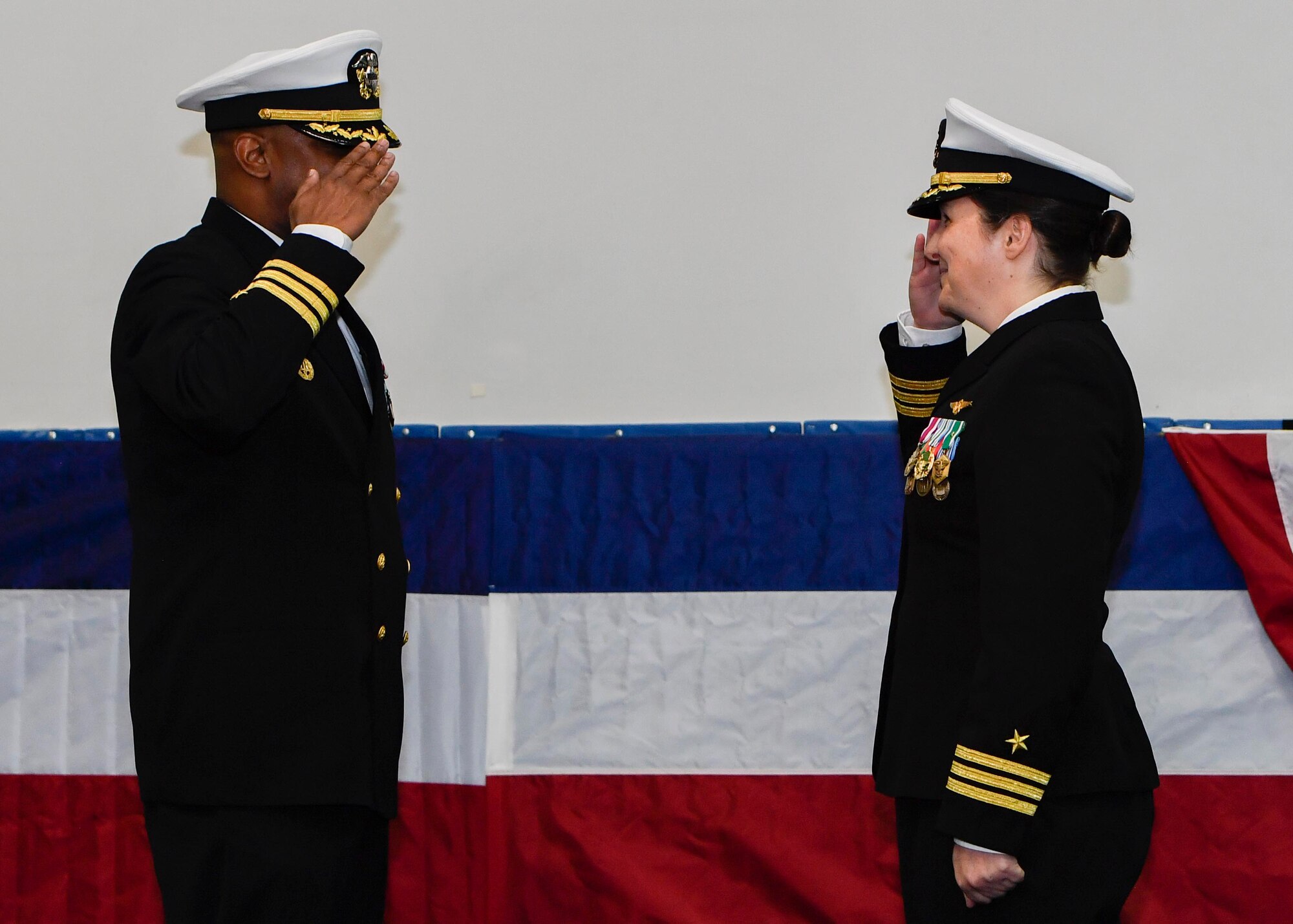 U.S. Navy Cdr. Teresa Ferry, left, relieves U.S. Navy Cdr. Stephen Jones, right, as Naval Operational Support Center Charleston commanding officer during a change of command ceremony at the Bowman Center on the Joint Base Charleston-Weapons Station, March 4, 2017. Ferry is arriving from Navy Reserve Forces Command while Jones is retiring after 20 years of service.
