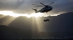 A CH-53E Super Stallion helicopter assigned to Marine Heavy Helicopter Squadron 463, carries a Humvee during an external lift training at Landing Zone West Field at Marine Corps Air Station Kaneohe Bay, Hawaii, March 8, 2017. This training improves proficiency for the pilots when moving supplies while Marines on the ground conditioned themselves to safely prepare dual and single load lifts.