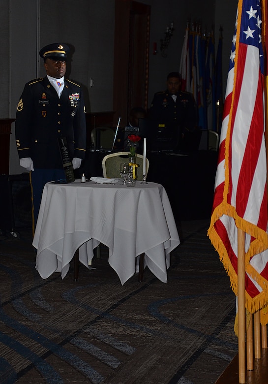 A U.S. Army Soldiers assigned to the 7th Transportation Brigade (Expeditionary) takes a moment of silence during the Resolute Ball in Newport News, Va., March 2, 2017. The Fallen Comrade Table is traditionally set up during a formal event in the memory of all fallen service members. (U.S Army photo/Staff Sgt. Miguel Bracero)
