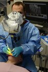 U.S. Army Maj. Bryan Horspool, U.S. Army Dental Command endodontist, examines a patient’s mouth during a procedure at the Tignor Dental Clinic at Joint Base Langley-Eustis, Va., March 10, 2017. During appointments, dentists use 3-D, panoramic and microscopes to view details in patients’ mouths that are not visible to the naked eye. (U.S. Air Force photo/Staff Sgt. Teresa J. Cleveland)