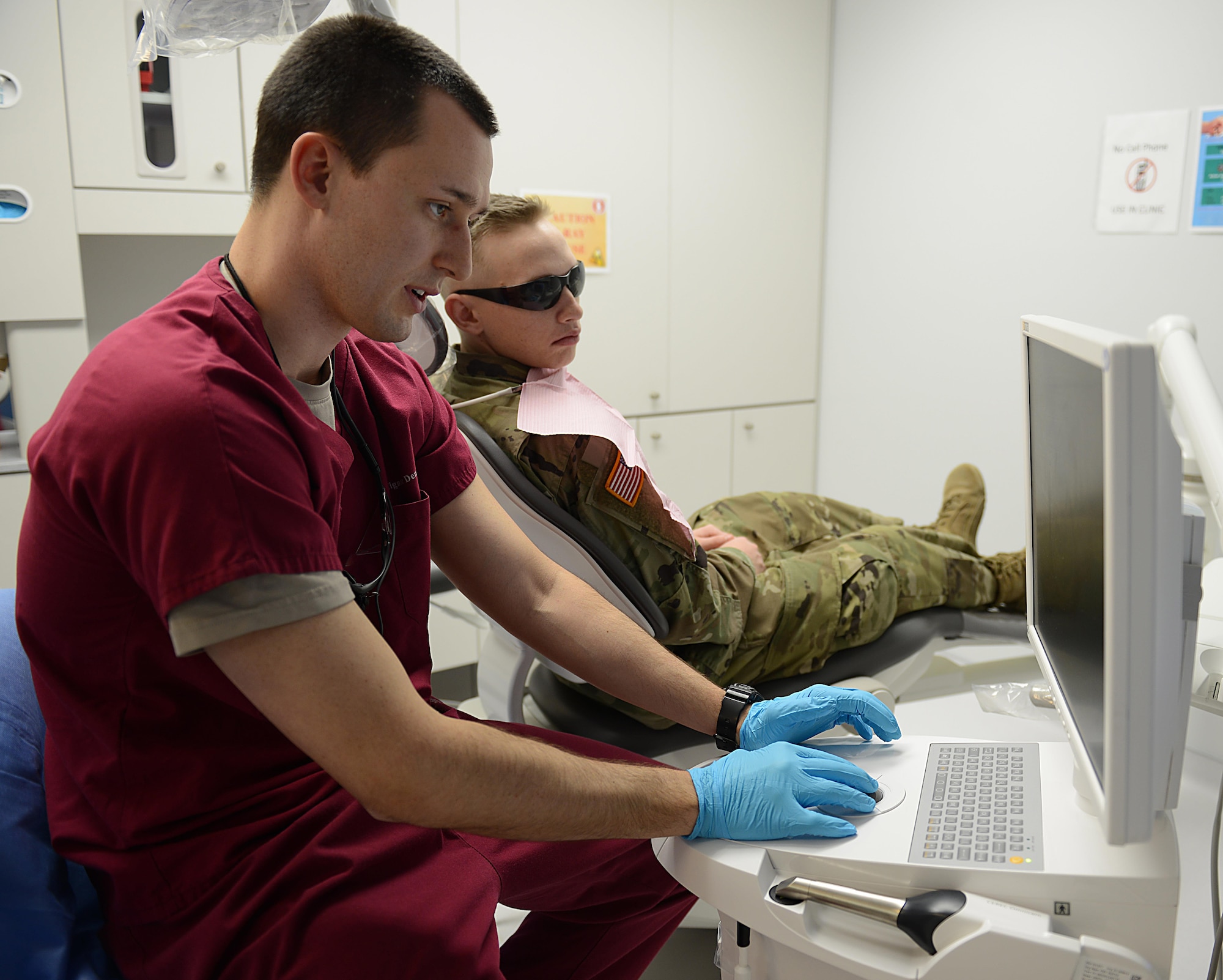 U.S. Army Capt. Tyler Oatmen, U.S. Army Dental Command dentist, explains a treatment plan to a patient at the Tignor Dental Clinic at Joint Base Langley-Eustis, Va., March 10, 2017. Technicians and dentists see approximately 7,000 Soldiers annually within the 28-chair clinic. (U.S. Air Force photo/Staff Sgt. Teresa J. Cleveland)