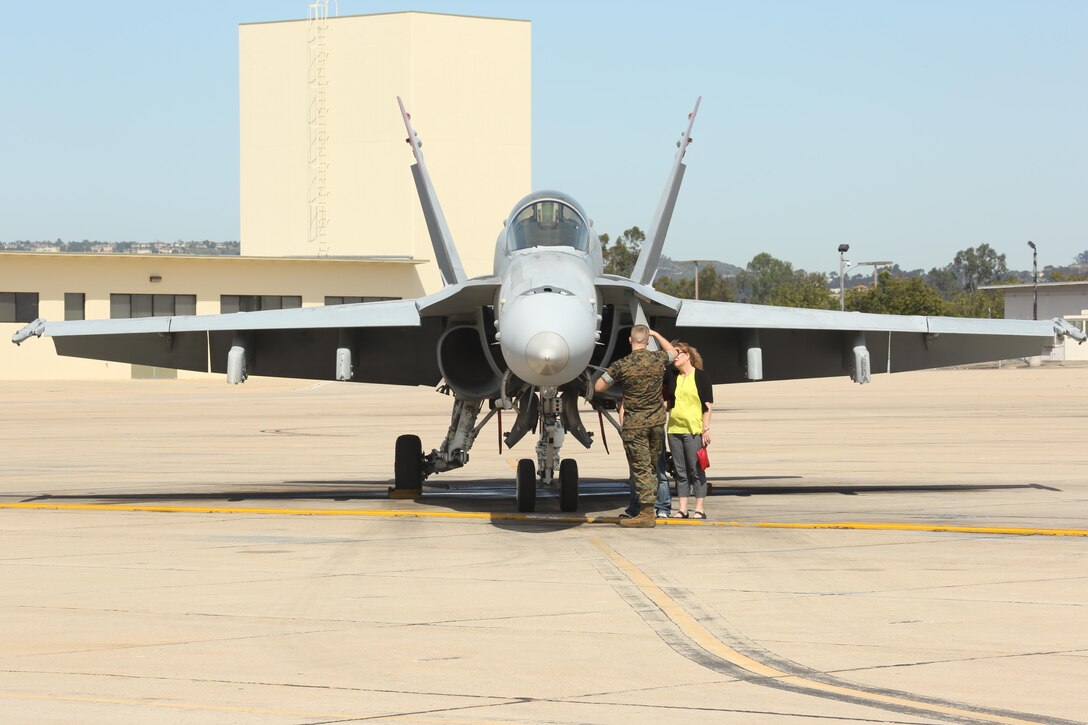 A Marine with Marine Fighter Attack Squadron (VMFA) 232 "Red Devils" shows an F/A-18C Hornet to his family at Marine Corps Air Station Miramar, Calif., March 14. More than 150 Marines with VMFA-232 deployed to participate in the unit deployment program at MCAS Iwakuni, Japan, March 14. (U.S. Marine Corps photo by Lance Cpl. Jake M.T. McClung/Released)