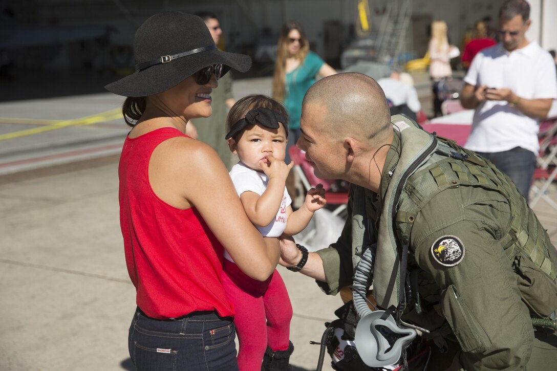 Maj. Ryan Franzen embraces his daughter, Keianna, before he boards an F/A-18C Hornet and prepares for takeoff on Marine Corps Air Station Miramar, Calif., March 11.  Marine Fighter Attack Squadron (VMFA) 232 “Red Devils,” the oldest Marine fighter attack squadron, will spend six months training in the Asia-Pacific region and northern America.  (U.S. Marine Corps photo by Sgt. David Bickel/Released)