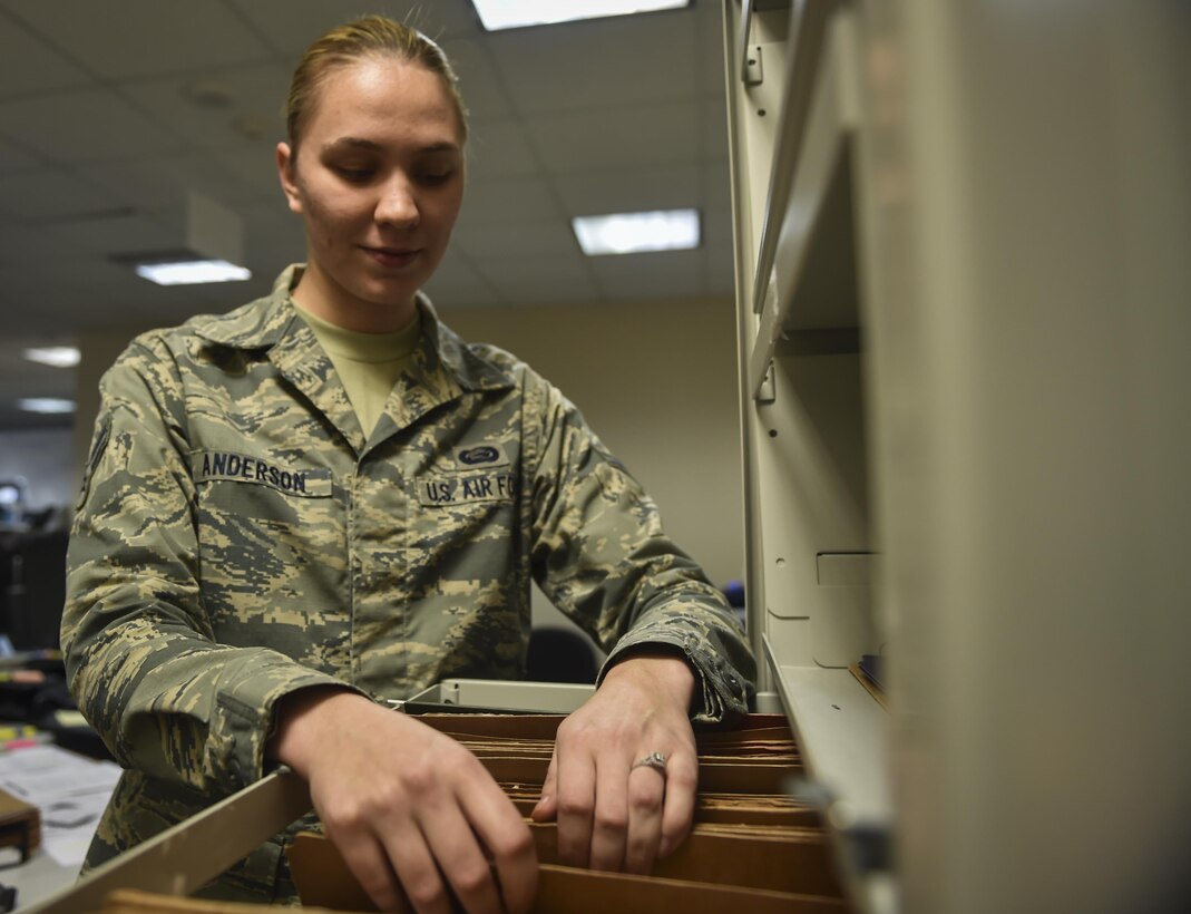 Airman 1st Class Briana Anderson, a re-enlistment and extension technician with the 1st Special Operations Force Support Squadron, sorts a re-enlistment file at the Military Personnel Flight on Hurlburt Field, Fla., March 14, 2017. Anderson is responsible for processing and reviewing re-enlistment, extension and bonus paperwork for Air Commandos. (U.S. Air Force photo by Airman 1st Class Joseph Pick)