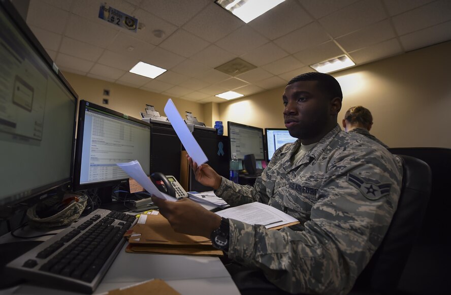 Airman 1st Class Adrian Basfield, a re-enlistment and extension technician with the 1st Special Operations Force Support Squadron, reviews re-enlistment folders for accuracy and discrepancies at the Military Personnel Flight on Hurlburt Field, Fla., March 14, 2017. Personnelists with the 1st SOFSS are broken into five sections: assignments, force management, promotions, re-enlistment and extensions, and retirement and separations. (U.S. Air Force photo by Airman 1st Class Joseph Pick)