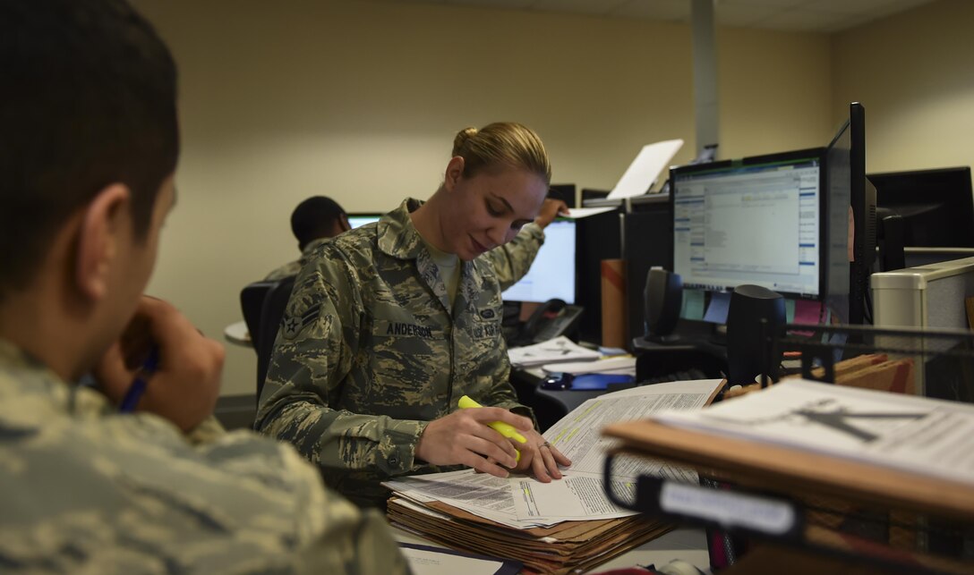 Airman 1st Class Briana Anderson, a re-enlistment and extension technician with the 1st Special Operations Force Support Squadron, assists a customer at the Military Personnel Flight on Hurlburt Field, Fla., March 14, 2017. Anderson is responsible for processing and reviewing re-enlistment, extension and bonus paperwork for Air Commandos. (U.S. Air Force photo by Airman 1st Class Joseph Pick)