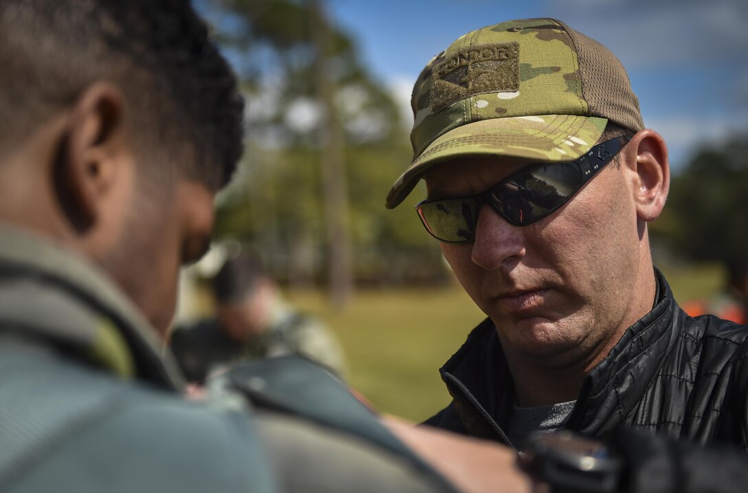 Staff Sgt. Tommy Dreher, a survival, evasion, resistance and escape specialist with the 1st Special Operations Support Squadron, assists an aircrew member with his harness during water survival training at Hurlburt Field, Fla., March 14, 2017. SERE specialists with the 1st SOSS instructed aircrew on three different required refresher trainings tri-annually to ensure aircrew are ready to execute operations. (U.S. Air Force photo by Airman 1st Class Joseph Pick)