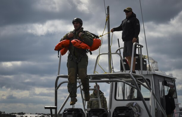 An aircrew member jumps into the Soundside during water survival training at Hurlburt Field, Fla., March 14, 2017. Water survival training is required for aircrew tri-annually to maintain proficiency on skill sets such as canopy disentanglement, parachute drop and drag, and life raft boarding.  (U.S. Air Force photo by Airman 1st Class Joseph Pick)