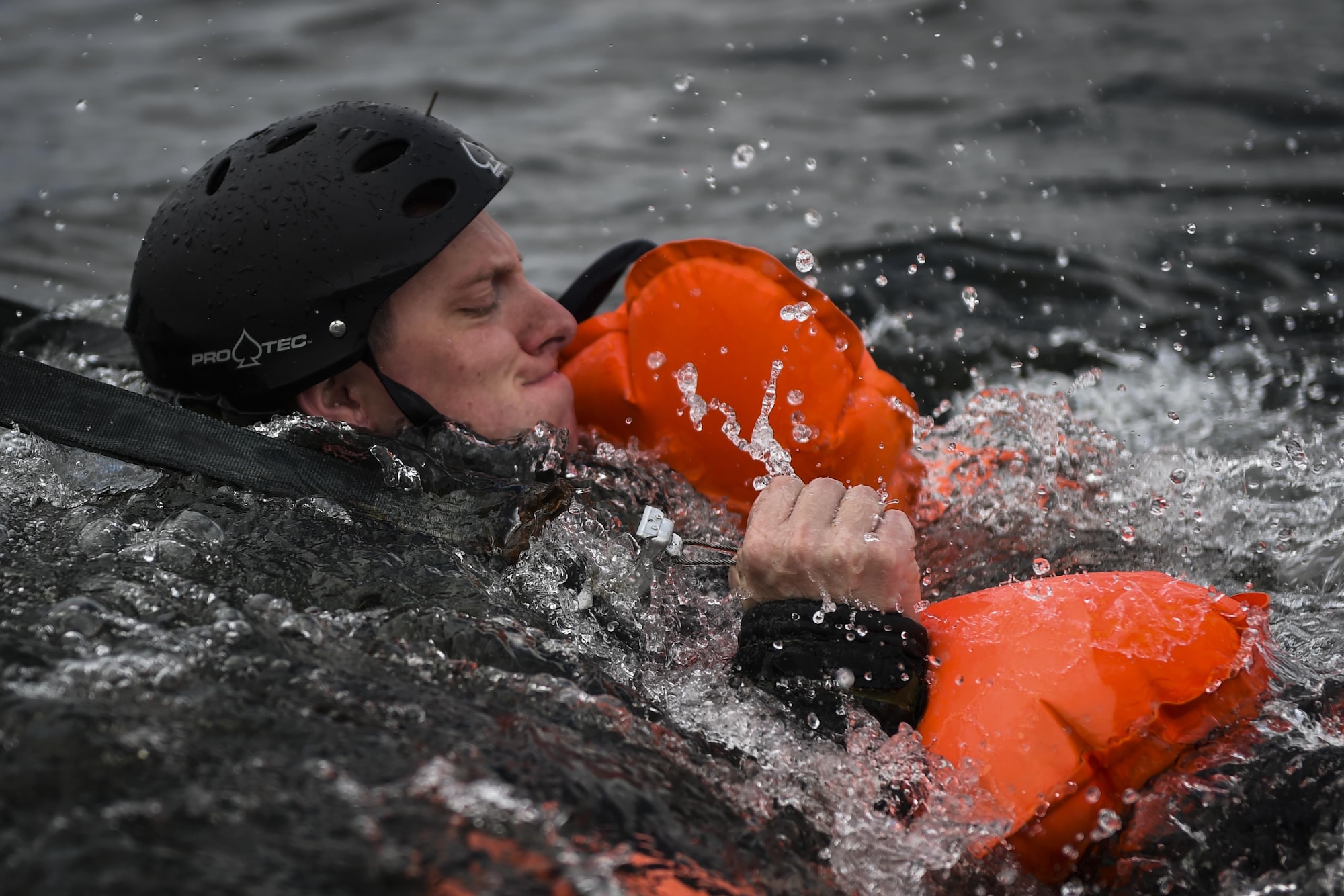 Staff Sgt. Josh Clements, a special missions aviator with the 4th Special Operations Squadron, releases from a simulated parachute during water survival training at Hurlburt Field, Fla., March 14, 2017. Aircrew must participate in combat, emergency parachute and water survival training tri-annually. (U.S. Air Force photo by Airman 1st Class Joseph Pick)