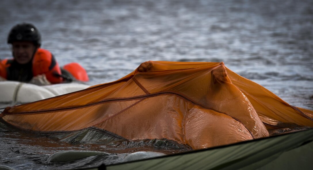 An aircrew member swims under a canopy during water survival training at Hurlburt Field, Fla., March 14, 2017. Water survival training is required for aircrew tri-annually to maintain proficiency on skill sets such as canopy disentanglement, parachute drop and drag, and life raft boarding.  (U.S. Air Force photo by Airman 1st Class Joseph Pick)