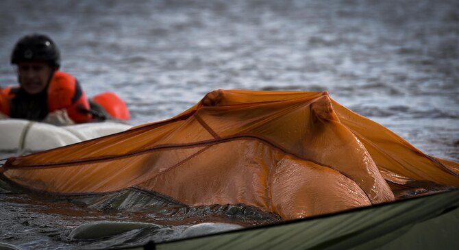An aircrew member swims under a canopy during water survival training at Hurlburt Field, Fla., March 14, 2017. Water survival training is required for aircrew tri-annually to maintain proficiency on skill sets such as canopy disentanglement, parachute drop and drag, and life raft boarding.  (U.S. Air Force photo by Airman 1st Class Joseph Pick)
