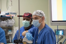 U.S. Air Force Maj. Adeleke Oyemade, left, a 60th Medical Group certified registered nurse anesthetist, watches on standby with Capt. Scott Abbott, a 35th Medical Group staff nurse anesthetist at Misawa Air Base, Japan, March 13, 2017. Senior surgeons came to Misawa to give guidance and refine clinical practices to use in contingency operations. (U.S. Air Force photo by Airman 1st Class Sadie Colbert)
