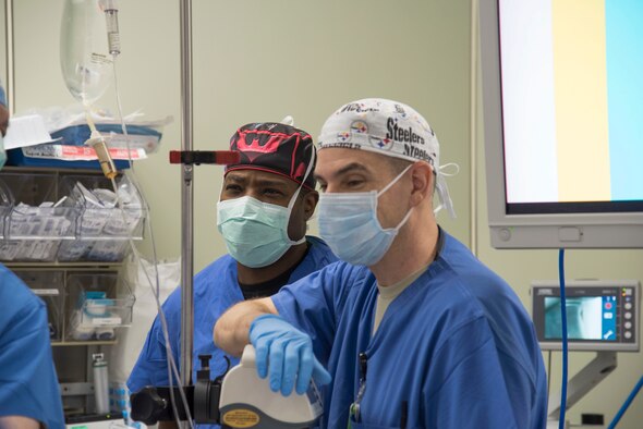 U.S. Air Force Maj. Adeleke Oyemade, left, a 60th Medical Group certified registered nurse anesthetist, watches on standby with Capt. Scott Abbott, a 35th Medical Group staff nurse anesthetist at Misawa Air Base, Japan, March 13, 2017. Senior surgeons came here to offer guidance and refine clinical practices to use in contingency operations. (U.S. Air Force photo by Airman 1st Class Sadie Colbert)