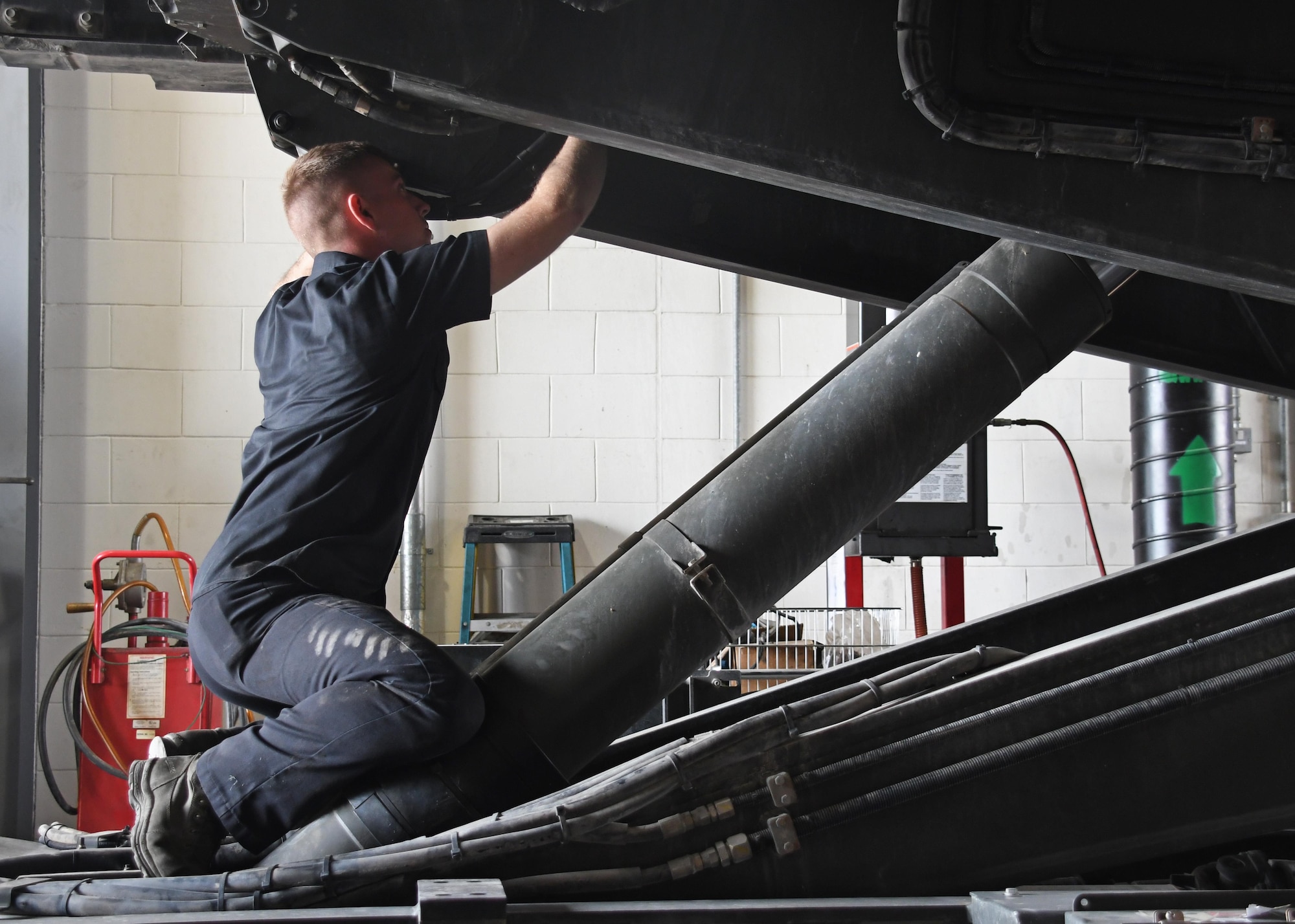 U.S. Air Force Staff Sgt. Michael Daniel, the material handling equipment NCO in charge with the 379th Expeditionary Logistics Readiness Squadron Vehicle Management Flight, repairs a hydraulic cylinder on a 25K loader at Al Udeid Air Base, Qatar, March 13, 2017. Hydraulic equipment uses hydraulic pressure to raise and lower weights that would otherwise be extremely difficult to use without the use of the 25K loaders, the Airmen at Al Udeid would be unable to load heavy cargo into aircraft such as the C-17 Globemaster III. (U.S. Air Force photo by Senior Airman Miles Wilson)