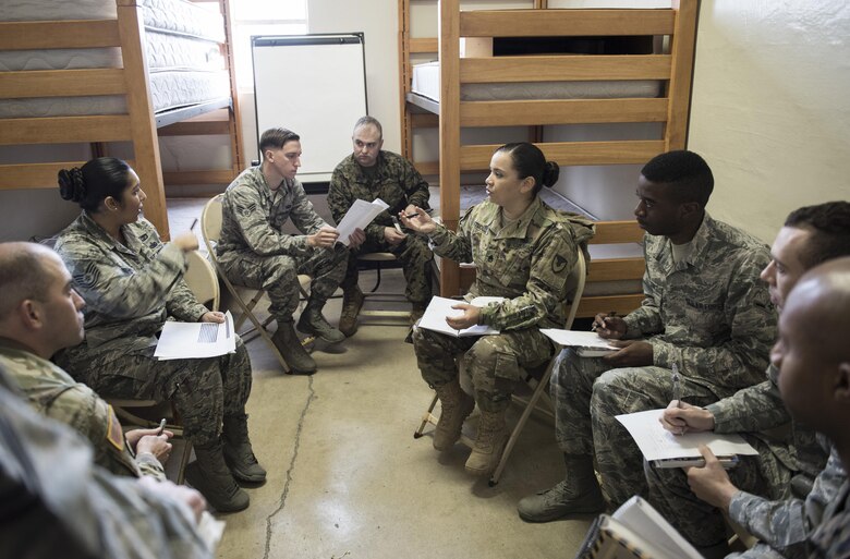 Contracting officers and finance agents from the U.S. Air Force, Army and Marine Corps work together as a team during an operational contracting support joint exercise Jan. 24, 2017, at Camp Foster, Japan. Training together prepares members of each branch to be able to function together in the event of a natural disaster. (U.S. Air Force photo by Senior Airman Omari Bernard)