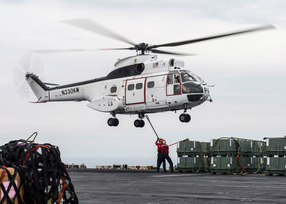 U.S. 5TH FLEET AREA OF OPERATIONS (March 11, 2017) Aviation Ordnanceman Jaymes Cudjo, from Harker Heights, Texas, and Aviation Ordnanceman 2nd Class Dillon Hays, from Kansas City, Mo., attach supplies to an SA-330J Puma helicopter aboard the amphibious assault ship USS Makin Island (LHD 8) during a vertical replenishment. Makin Island is deployed in the U.S. 5th Fleet area of operations in support of maritime security operations designed to reassure allies and partners, and preserve the freedom of navigation and the free flow of commerce in the region. (U.S. Navy photo by Mass Communication Specialist 3rd Class Devin M. Langer)