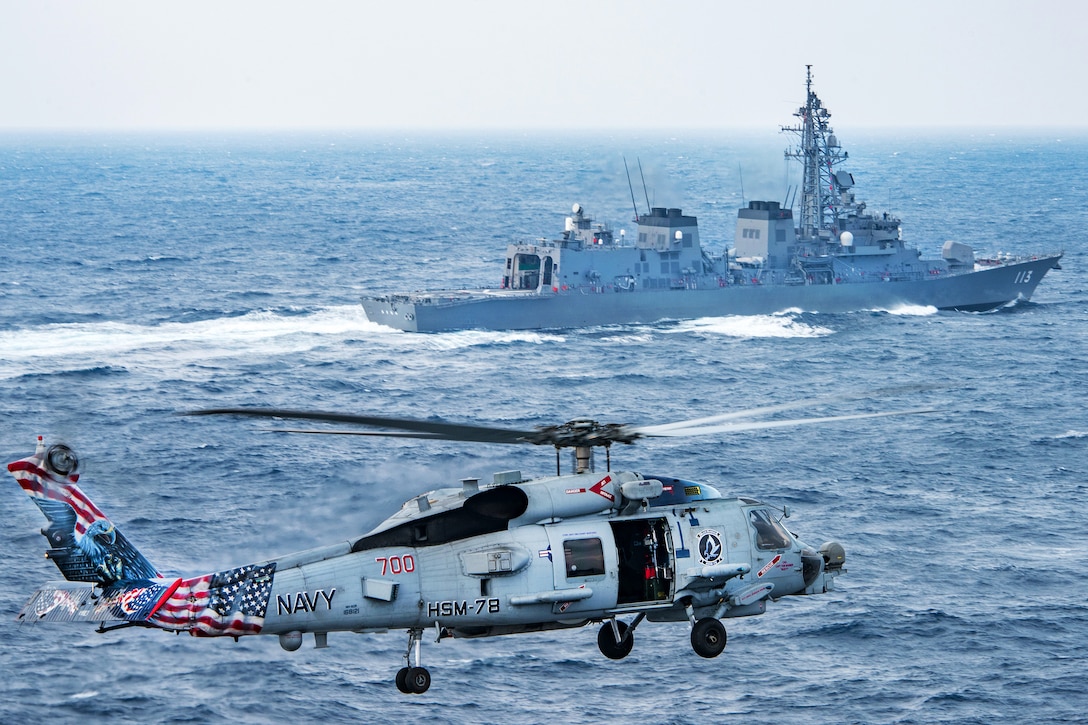 An MH-60R Sea Hawk helicopter flies near the Japan Maritime Self-Defense Force Takanami-class destroyer JS Sazanami and the aircraft carrier USS Carl Vinson, not shown, in the East China Sea, March 8, 2017. The crew is assigned to Helicopter Maritime Strike Squadron 78. Navy photo by Petty Officer 2nd Class Sean M. Castellano